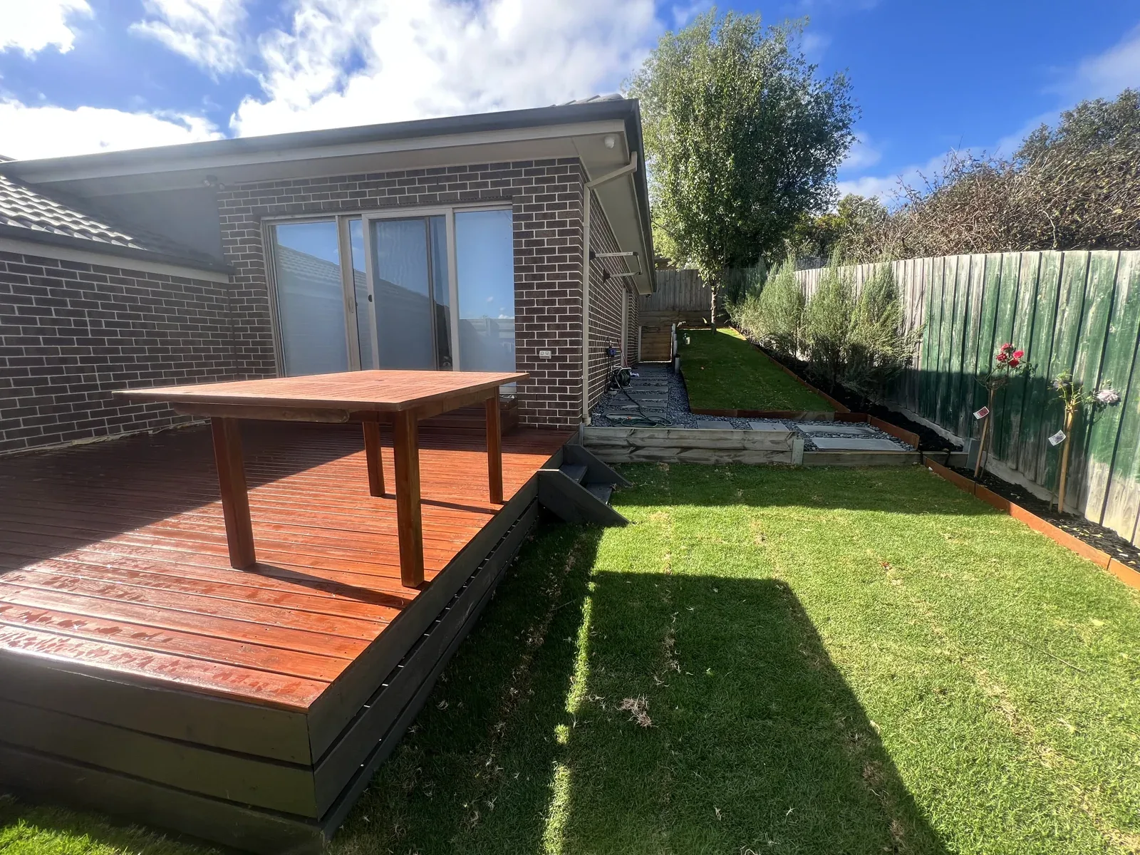 Timber entertaining deck alongside a new lawn and garden path