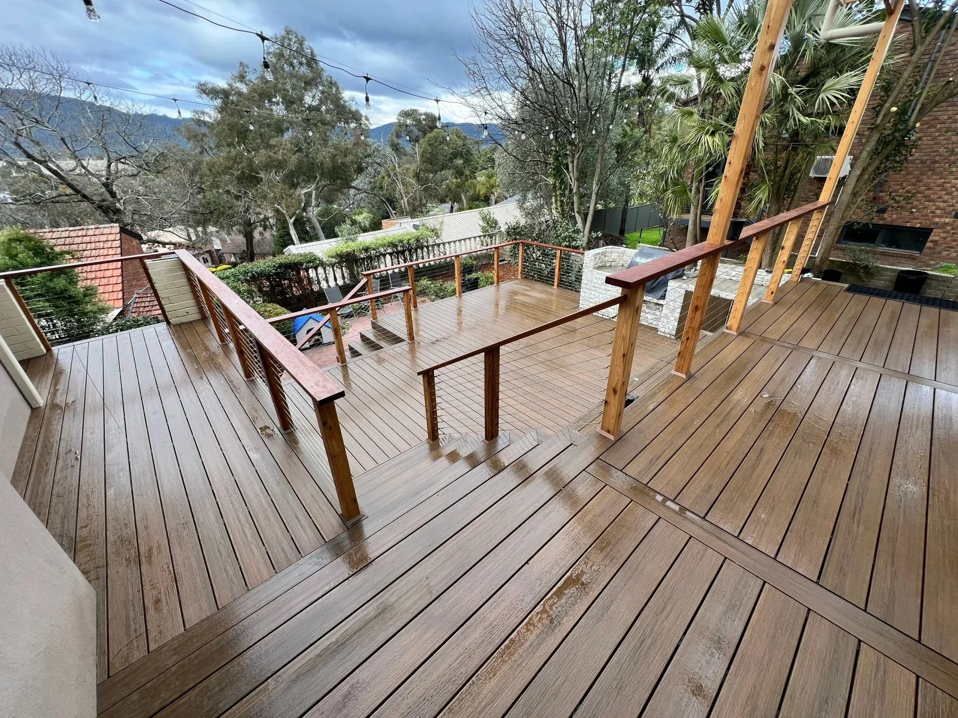 Multi-level timber deck with stairs and cable balustrades overlooking the treetops