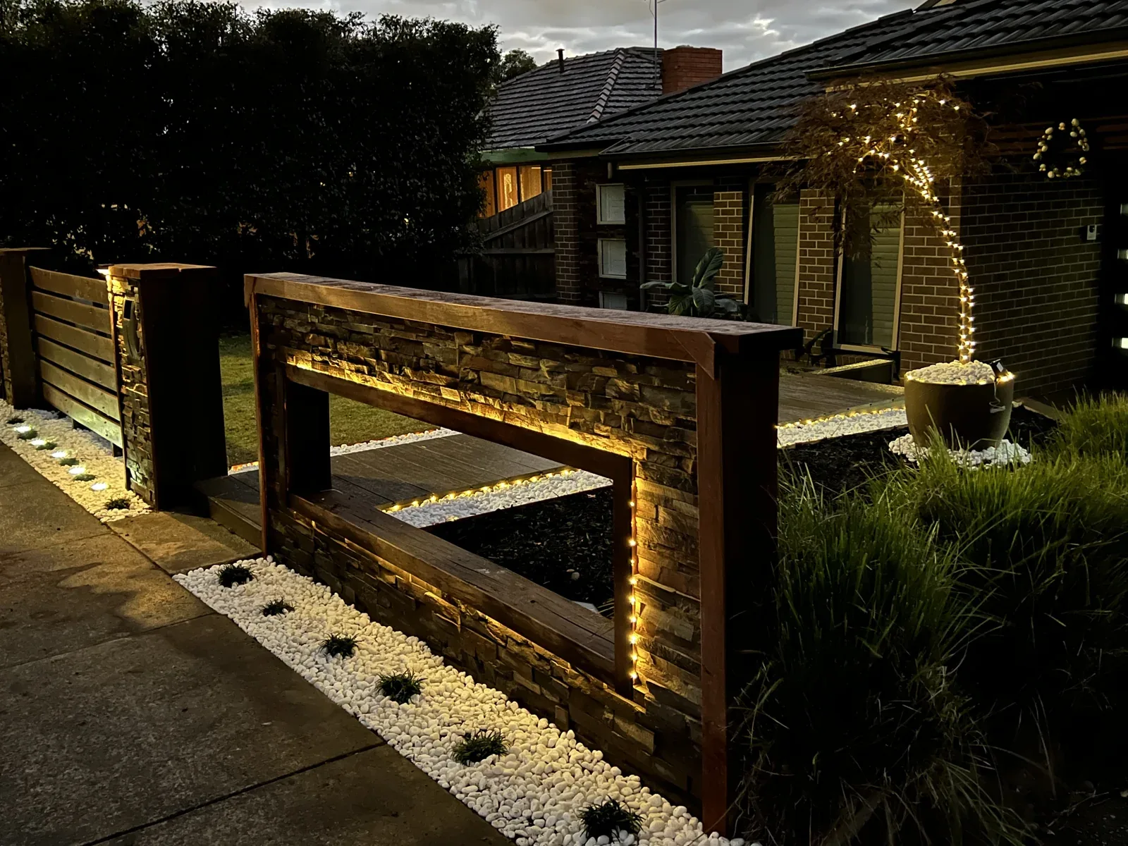 Timber garden entrance and landscape details at night